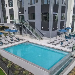 a resort-style pool with a building behind it
