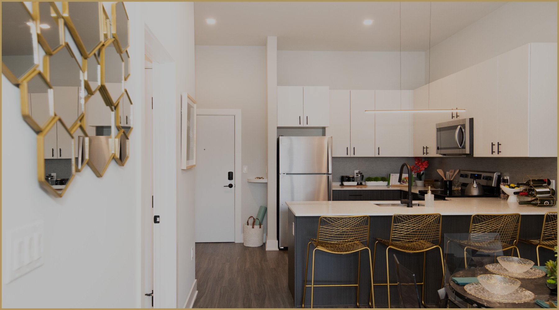 a kitchen and dining room with seating table and mirror